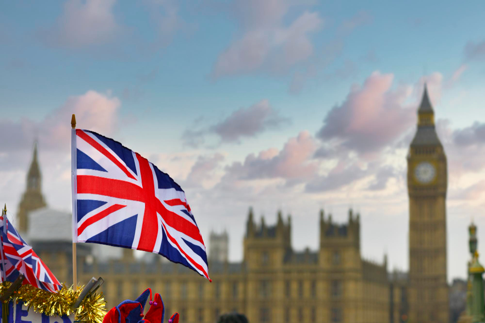 Union Jack British flag waving against blue sky