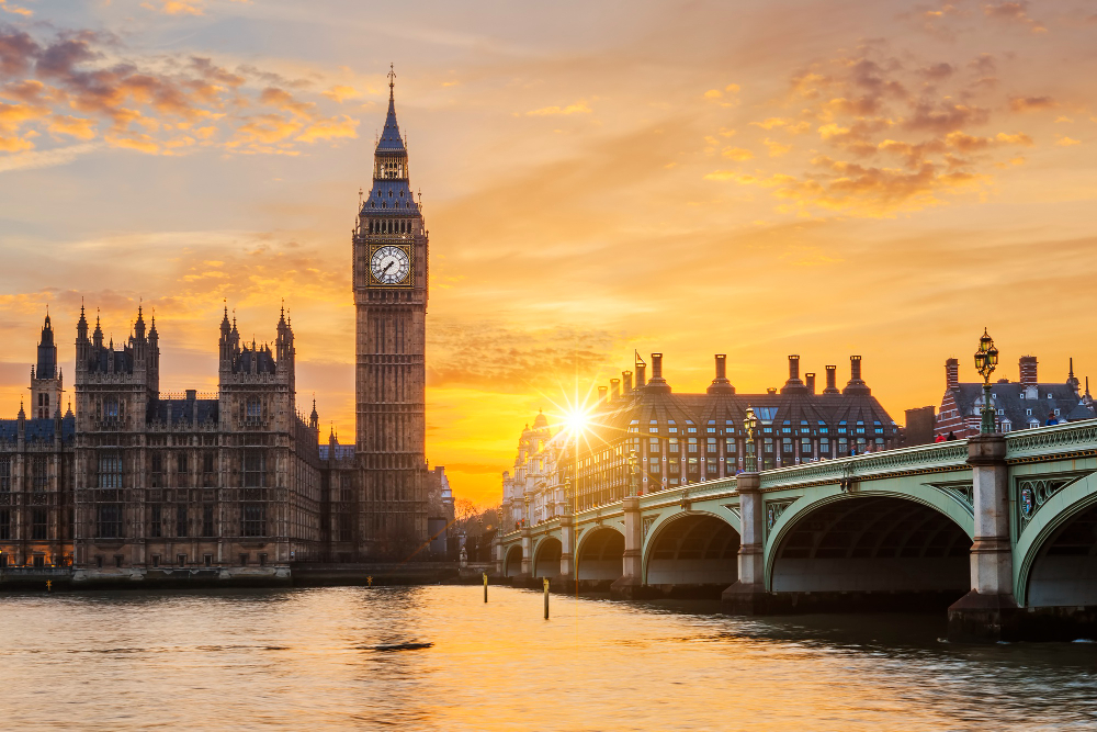 Sunset view of Big Ben and the Houses of Parliament in London beside the River Thames.
