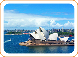 The Sydney Opera House with its iconic white sail-like design, surrounded by blue water and boats, with the city skyline in the background.
