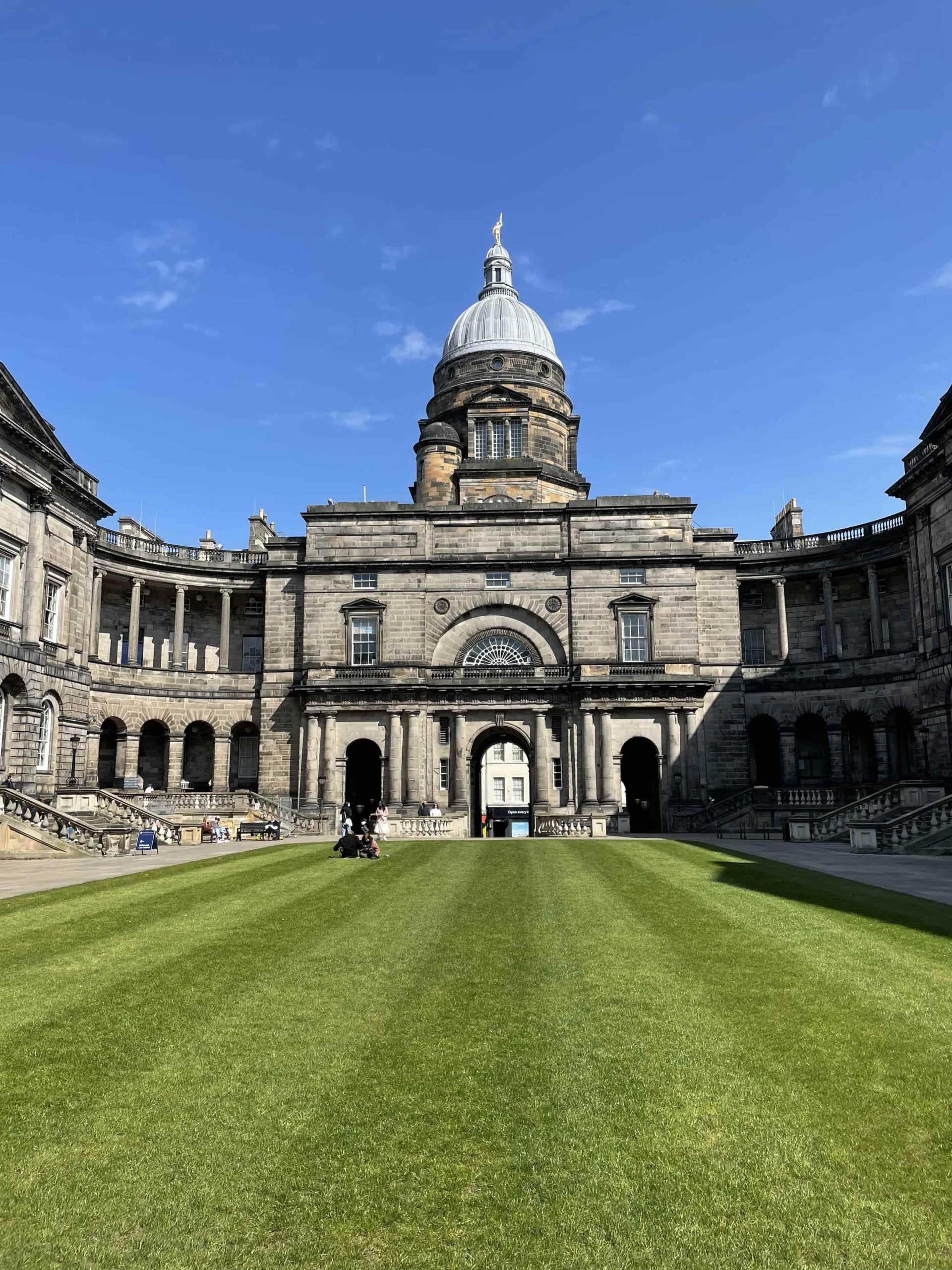 Ornate government or university building with classical columns and dome