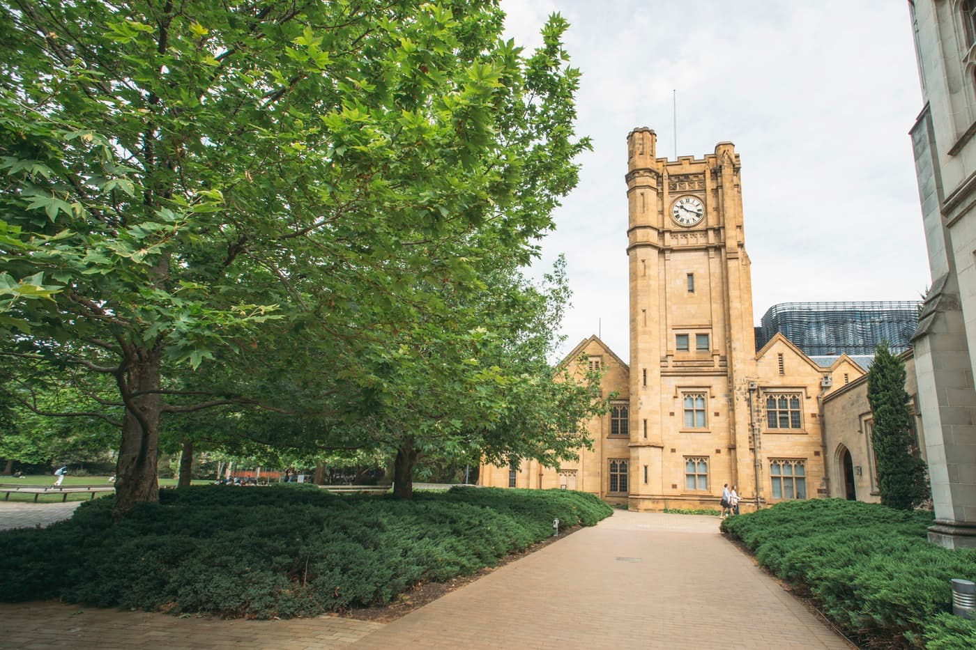 University or college campus building with tower and green lawn