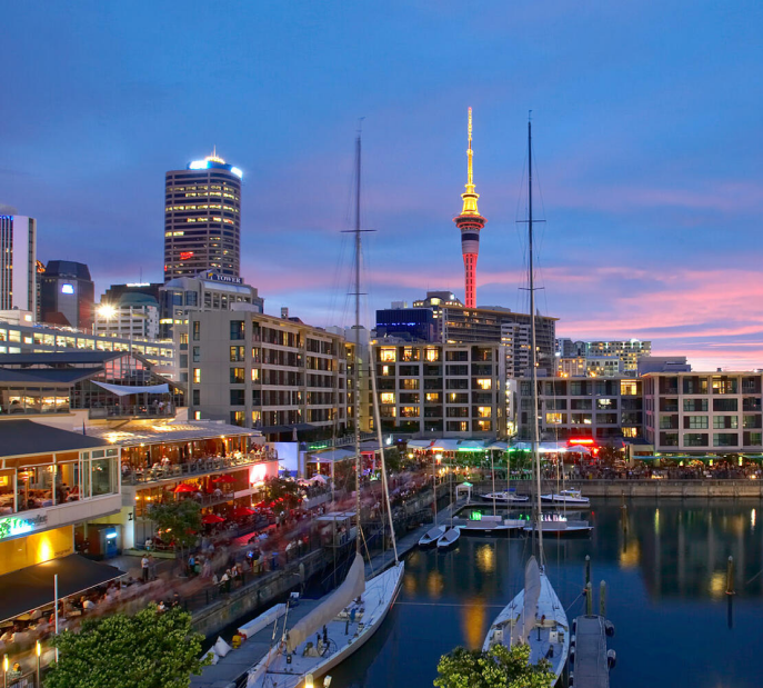 Frankfurt skyline at dusk with illuminated skyscrapers reflected in river