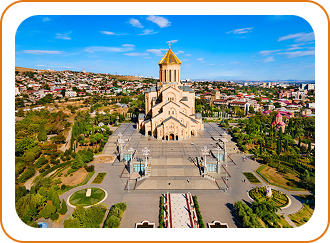 Statue or monument on hilltop overlooking a city